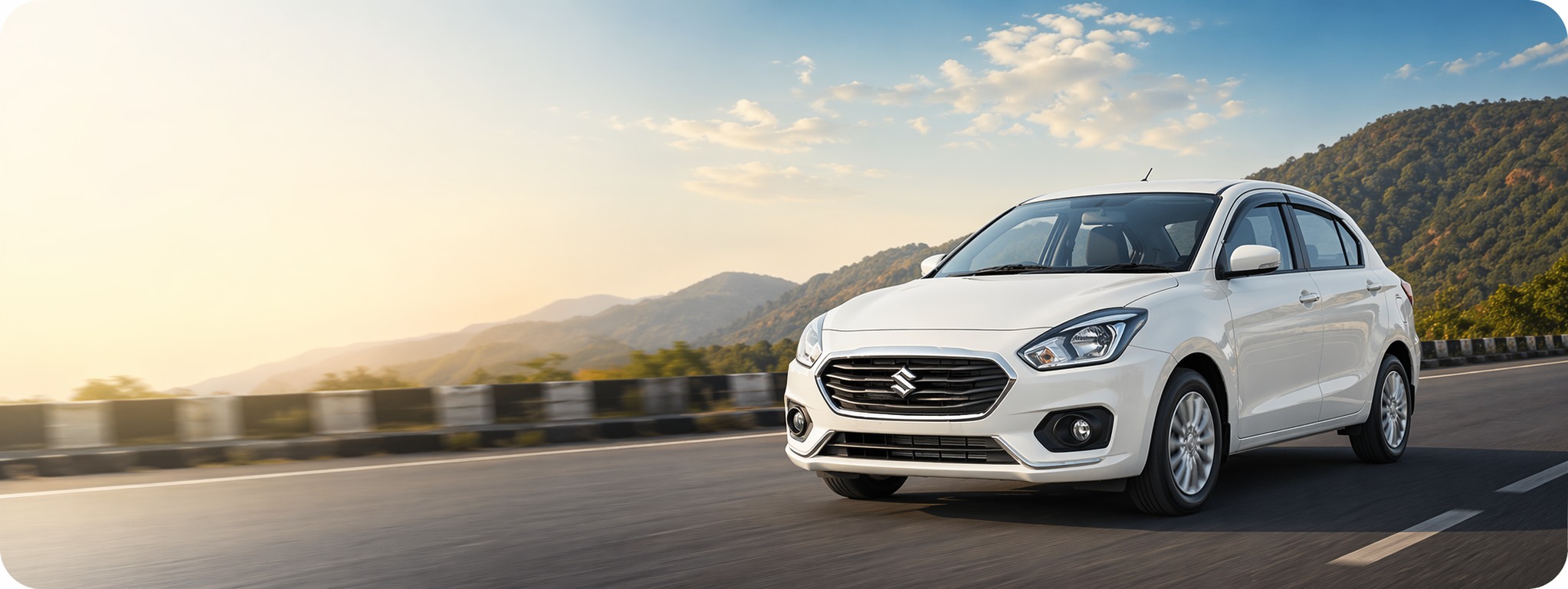 Modern white sedan on scenic highway for Srinivasa Car Travels